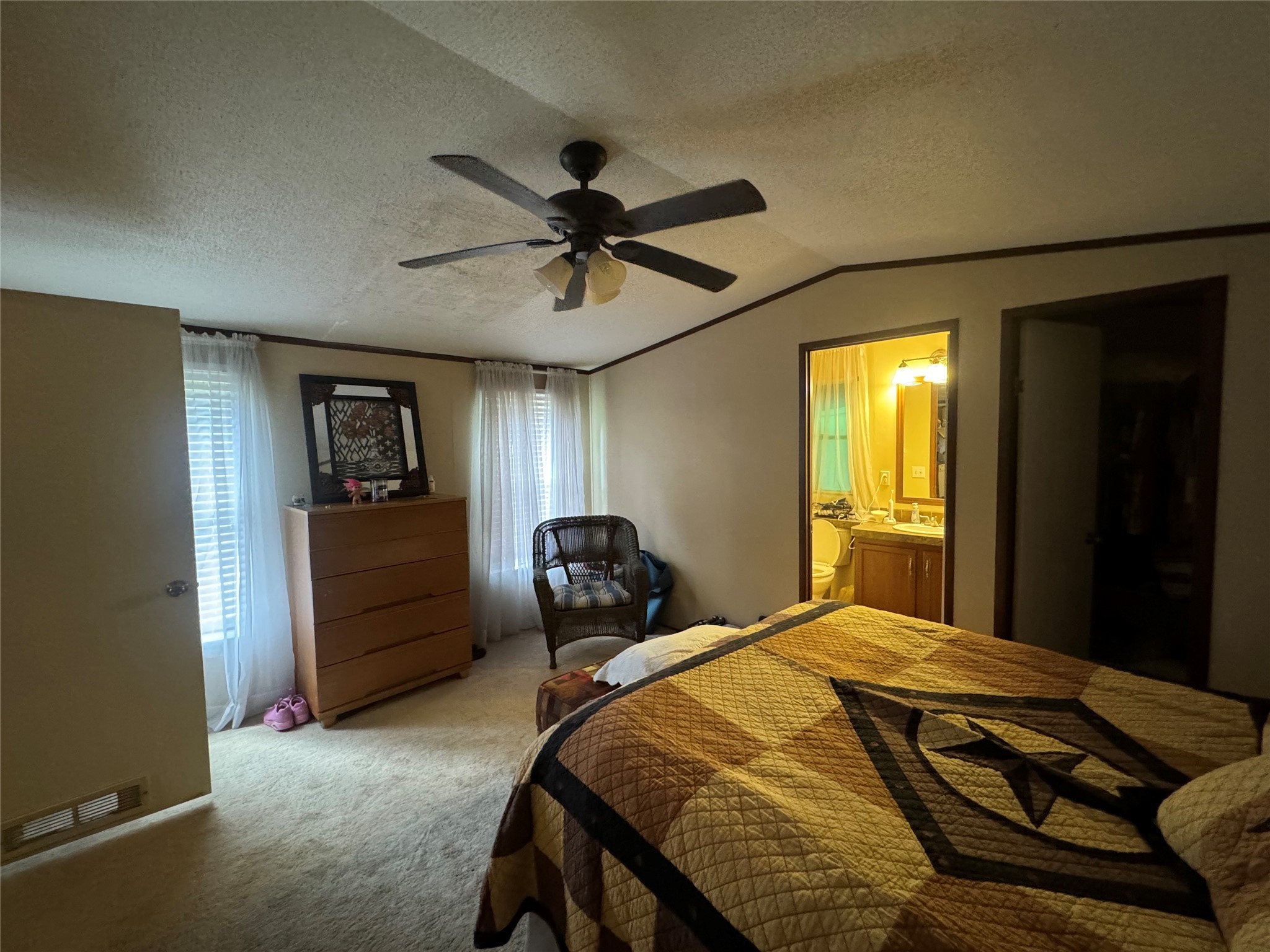 18 Mockingbird Trinity, TX 75862 - Photo 22 of 30 a bedroom with a bed and a chandelier