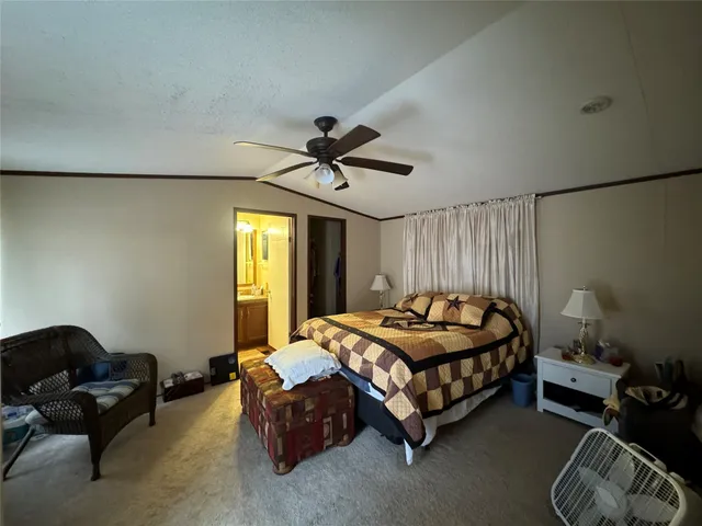 a bedroom with a bed couch and a window