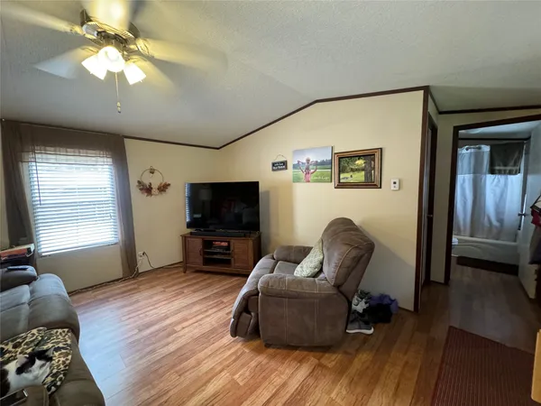 a bathroom with a granite countertop sink toilet a mirror a vanity and shower