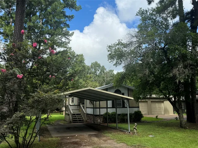 a view of a wooden deck with a yard