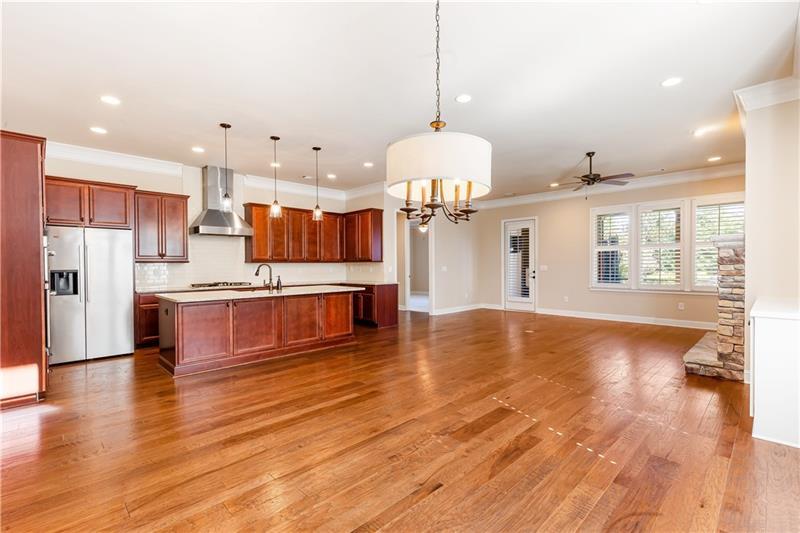 424 Loblolly Street Woodstock, GA 30188 - Photo 17 of 57 a open kitchen with stainless steel appliances granite countertop a stove refrigerator and a wooden floor