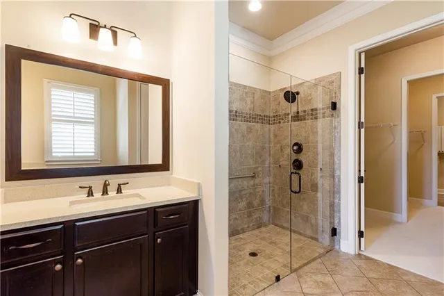 a bathroom with a shower sink and mirror