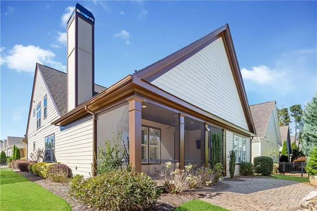 a view of a house with garden and a sitting area
