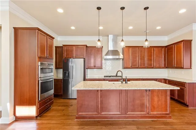 a kitchen with stainless steel appliances granite countertop a sink refrigerator and cabinets