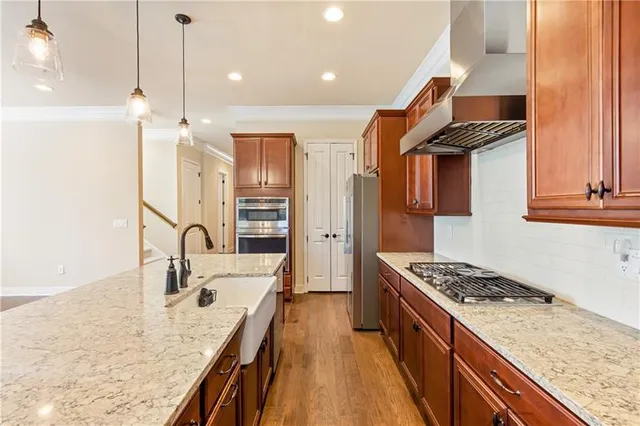 a kitchen with stainless steel appliances granite countertop a sink stove and refrigerator