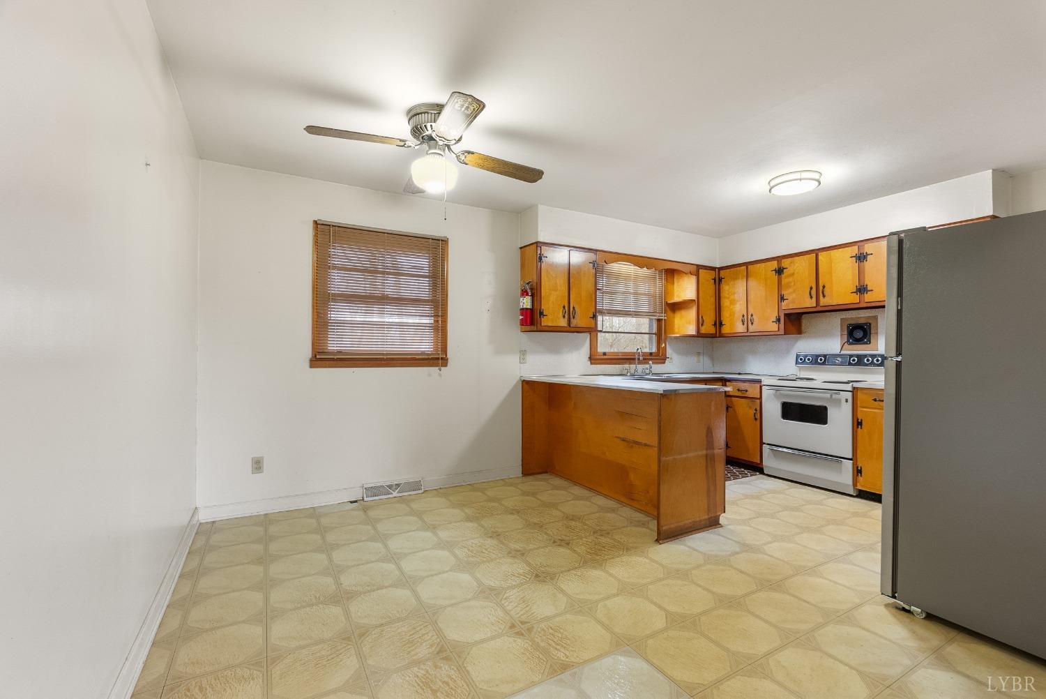 528 Jasper Wood Road Hurt, VA 24563 - Photo 11 of 44 a kitchen with stainless steel appliances granite countertop a sink cabinets and window
