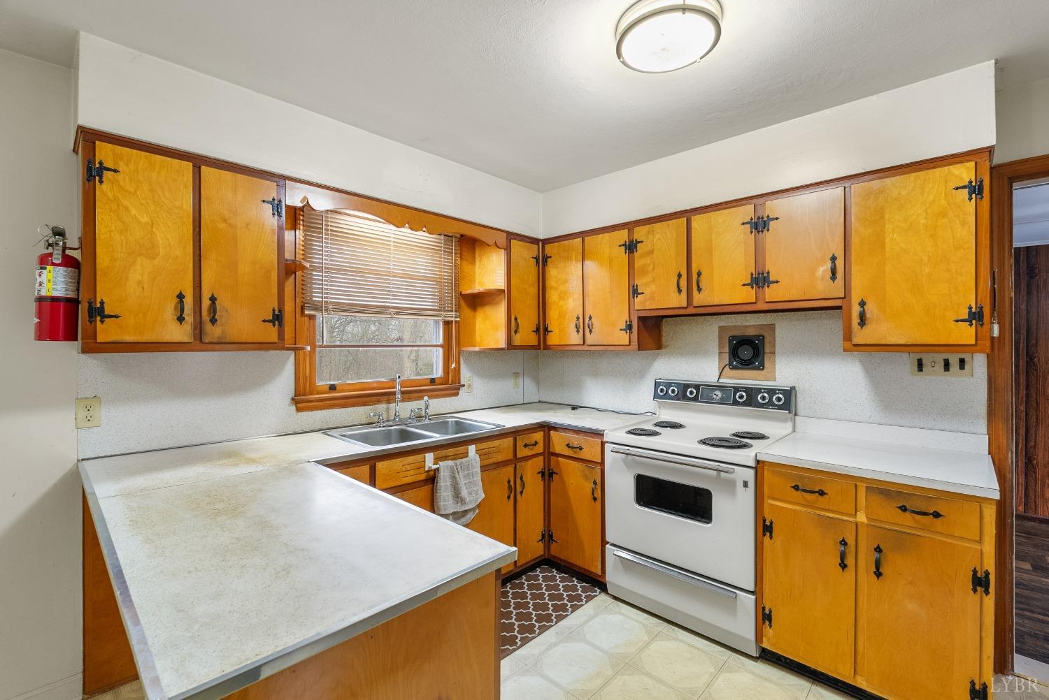 528 Jasper Wood Road Hurt, VA 24563 - Photo 13 of 44 a kitchen with a sink stove top oven and cabinets