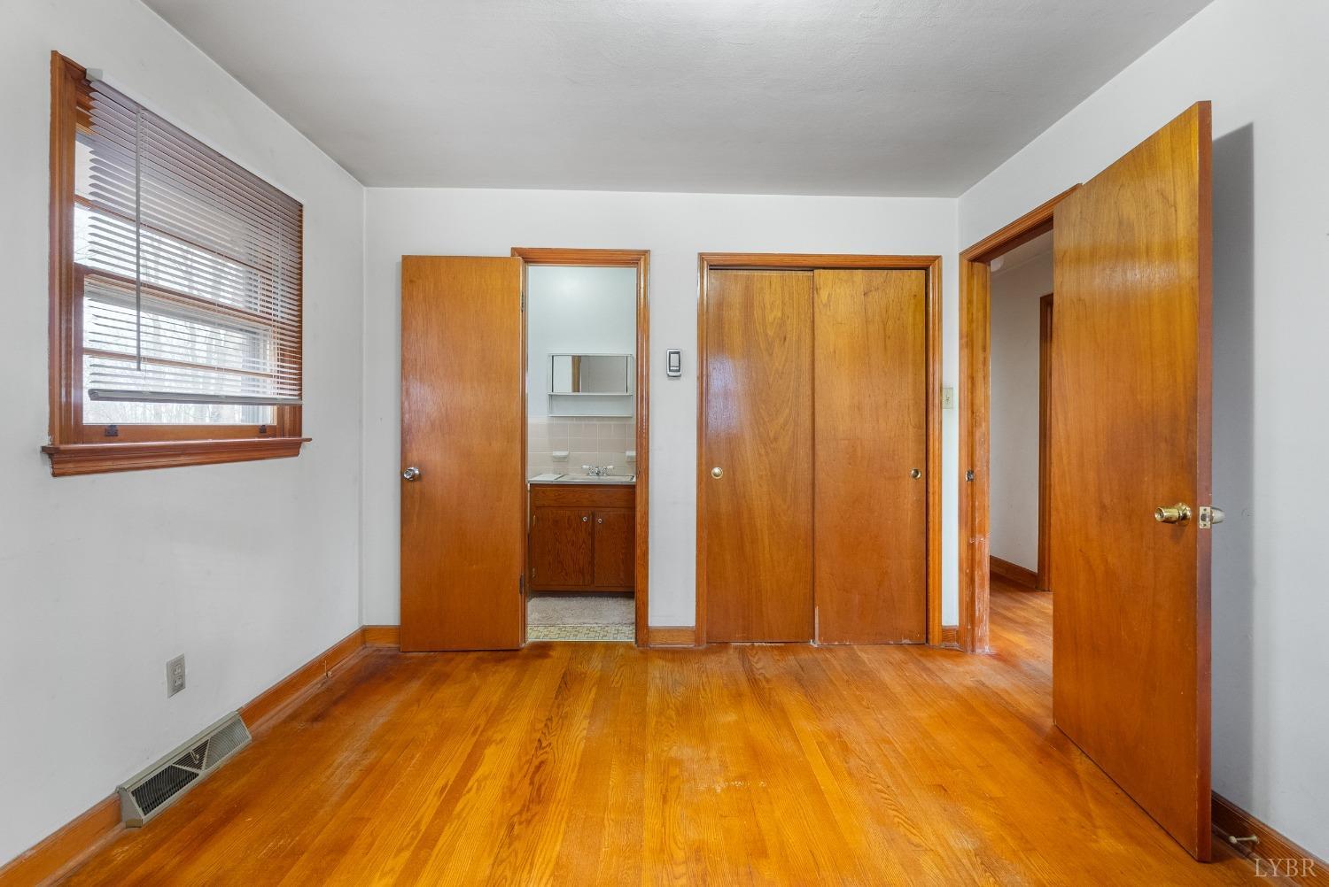 528 Jasper Wood Road Hurt, VA 24563 - Photo 27 of 44 a view of an empty room with wooden floor and a window