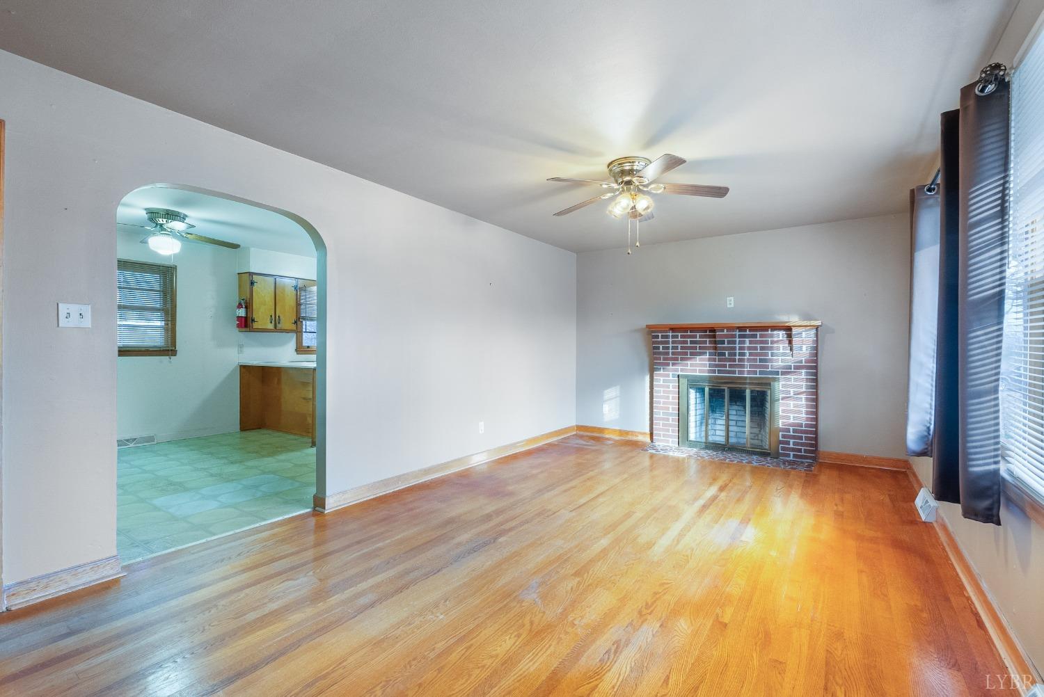 528 Jasper Wood Road Hurt, VA 24563 - Photo 9 of 44 wooden floor in an empty room with a fireplace