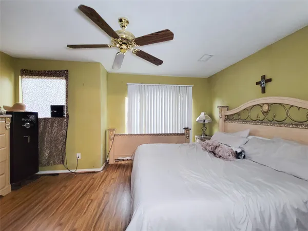 a bedroom with a bed and wooden floor