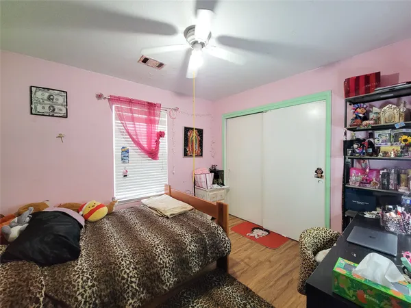 a bedroom with a bed dresser and a window