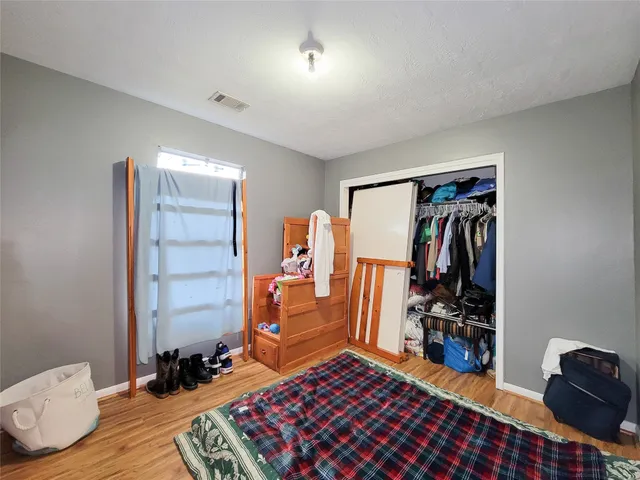 a bedroom with furniture and a closet