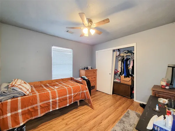 a bedroom with a bed and closet