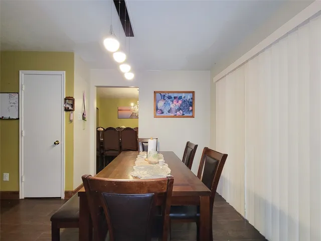 a dining room with furniture and wooden floor