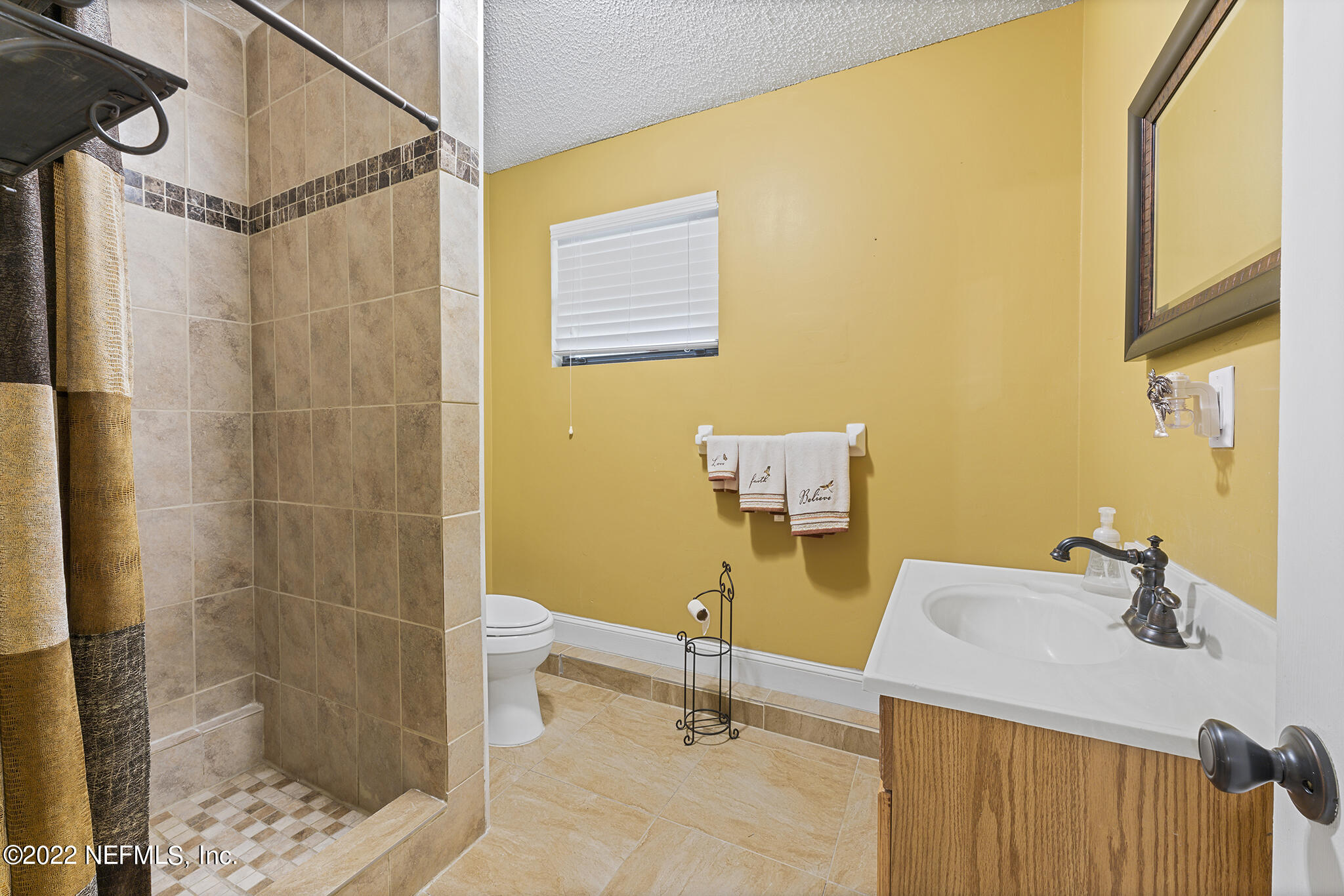 6130 Firestone Road Jacksonville, FL 32244 - Photo 20 of 67 a bathroom with a sink and a mirror