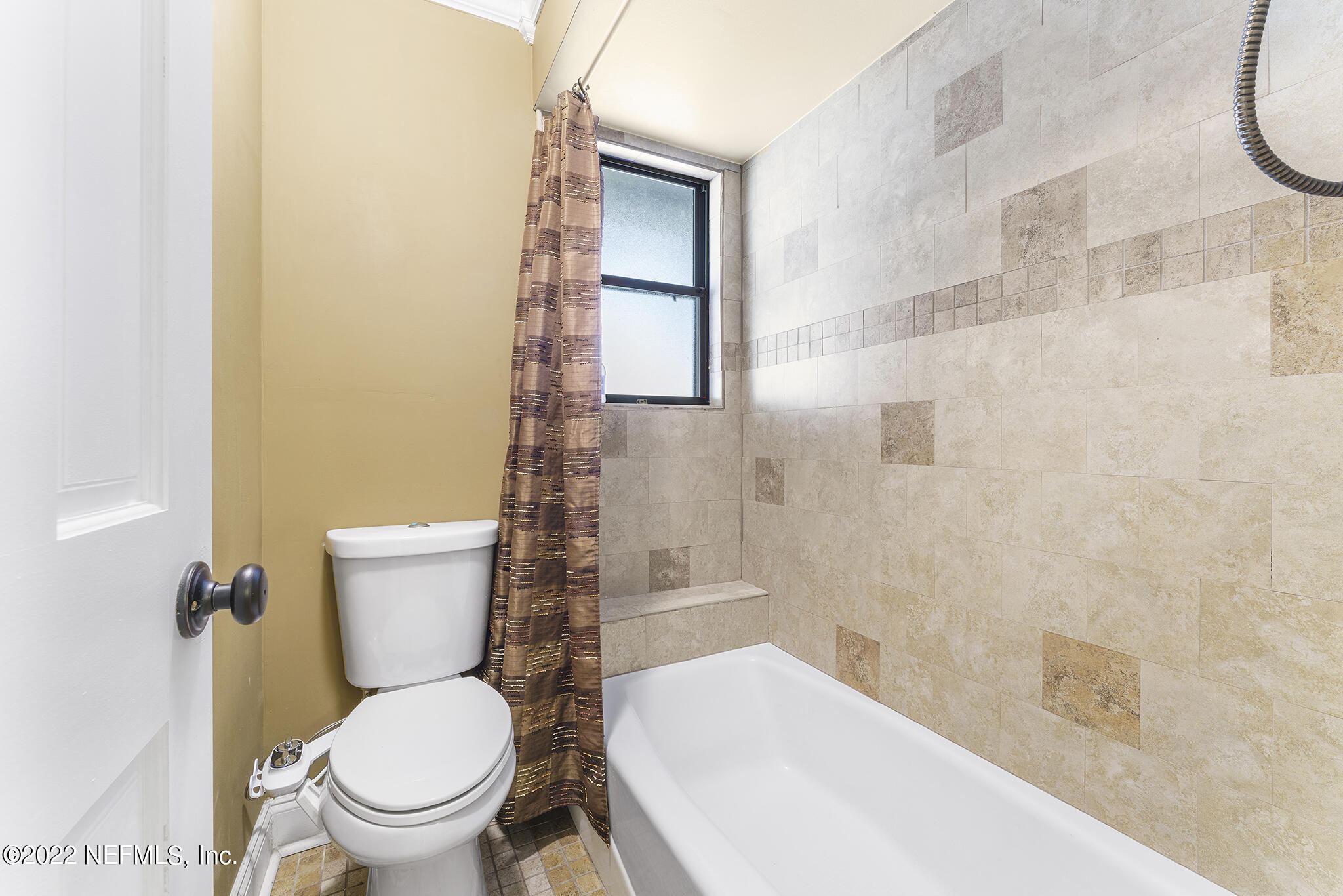 6130 Firestone Road Jacksonville, FL 32244 - Photo 24 of 67 a white toilet sitting next to a bath tub