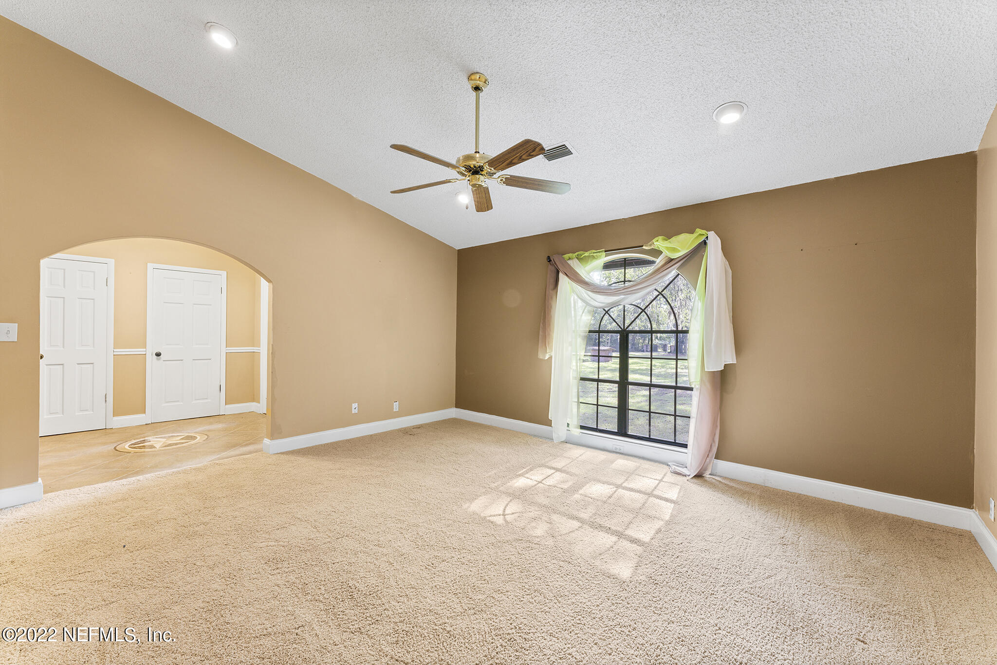 6130 Firestone Road Jacksonville, FL 32244 - Photo 32 of 67 an empty room with windows and ceiling fan