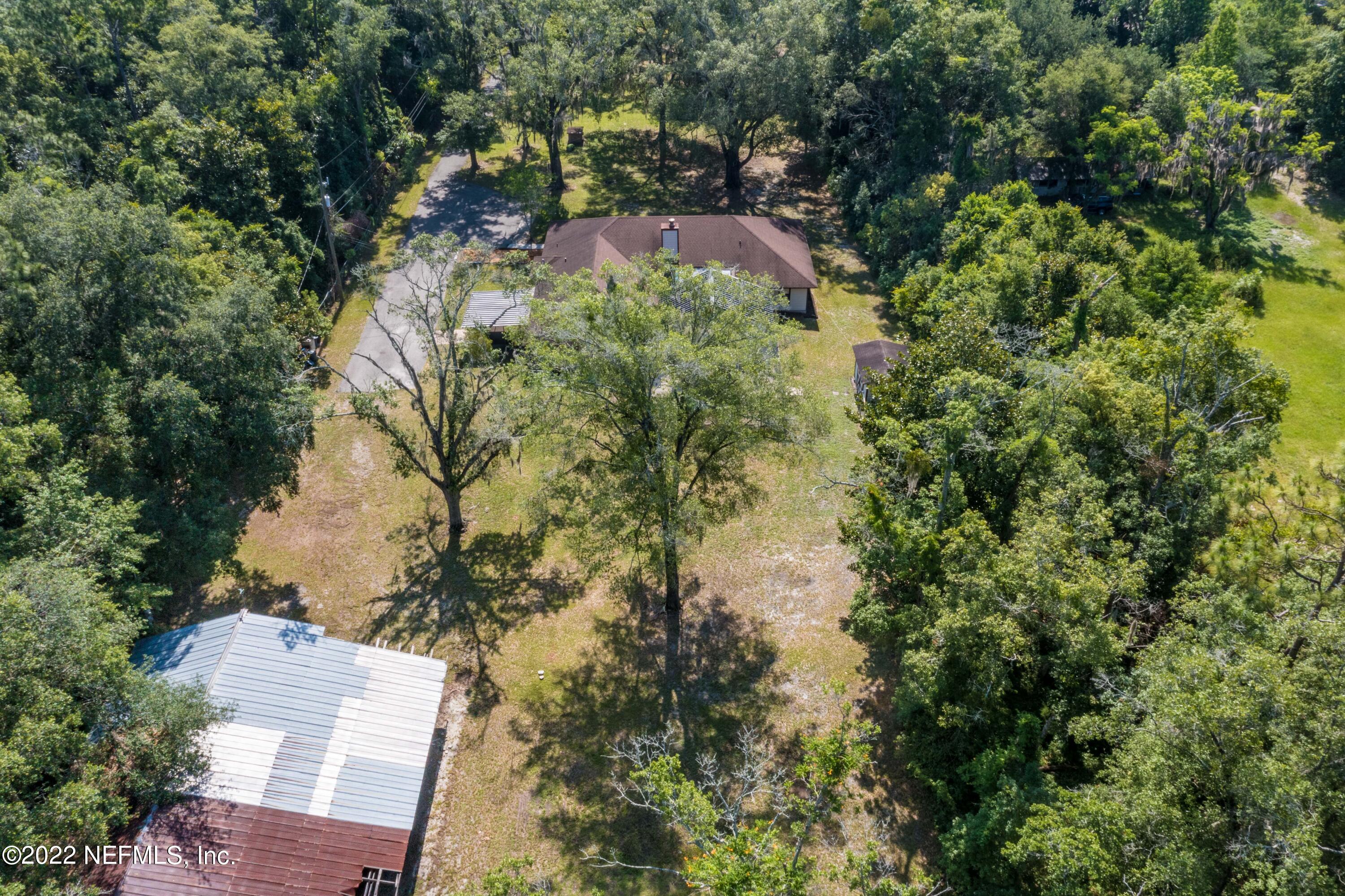 6130 Firestone Road Jacksonville, FL 32244 - Photo 38 of 67 an aerial view of a house with a yard and large trees