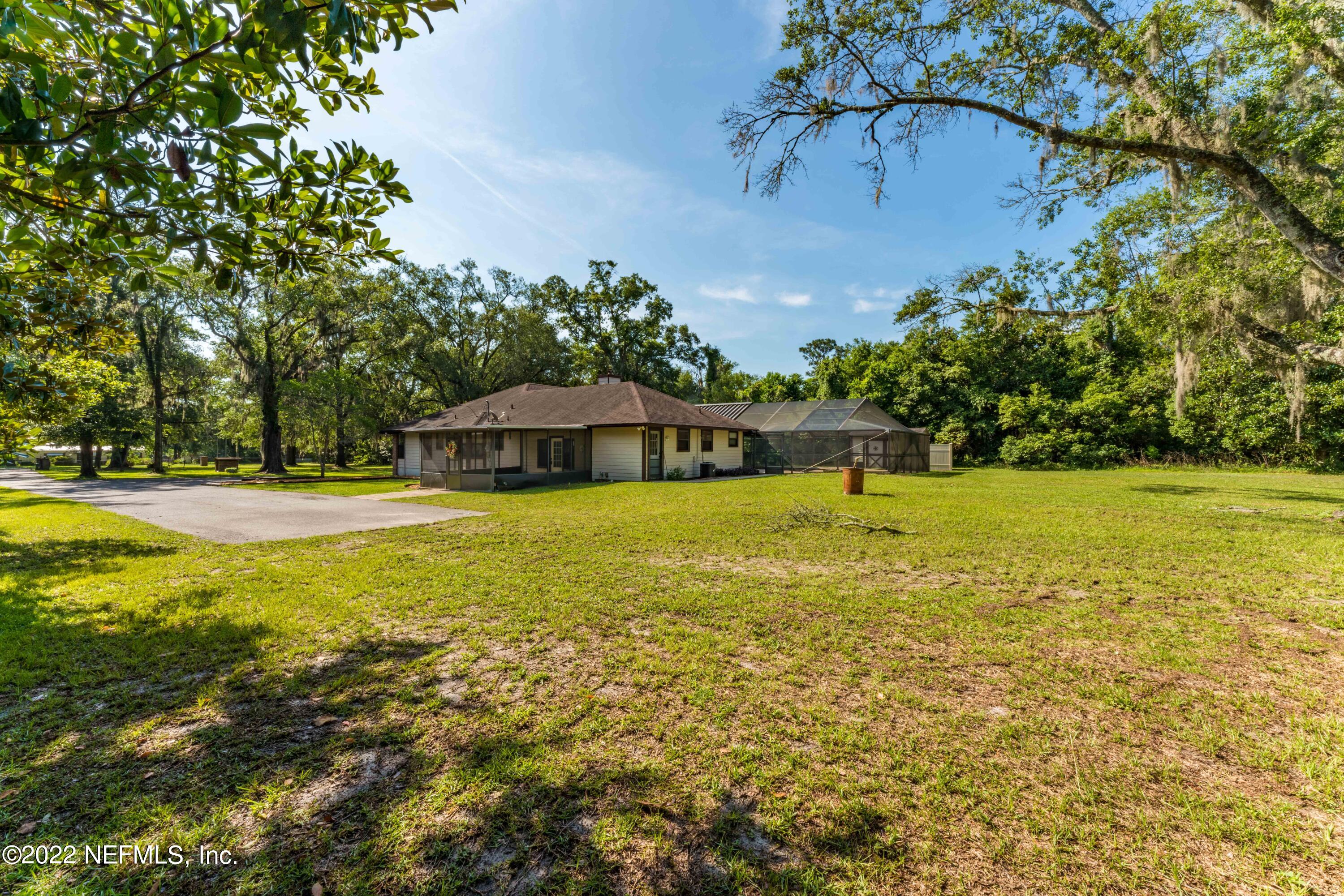 6130 Firestone Road Jacksonville, FL 32244 - Photo 58 of 67 a view of a swimming pool with an outdoor space and seating area