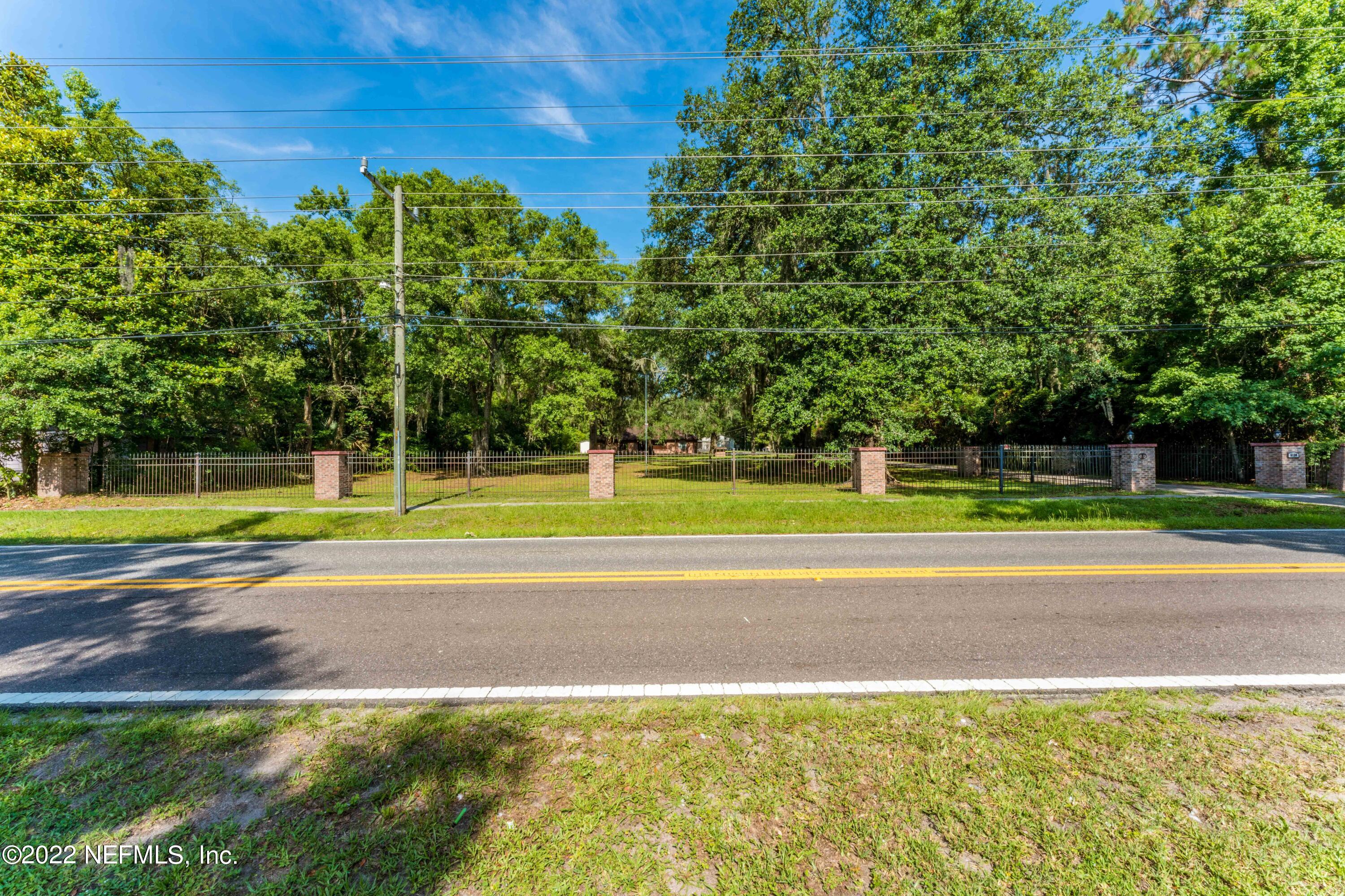 6130 Firestone Road Jacksonville, FL 32244 - Photo 64 of 67 a view of a tennis ground with a large trees