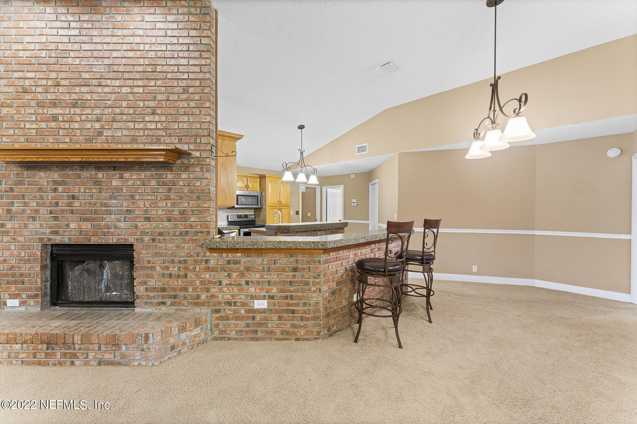 6130 Firestone Road Jacksonville, FL 32244 - Photo 10 of 67 a dining room with furniture and a fireplace