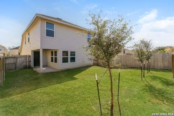 a house view with swimming pool in front of it