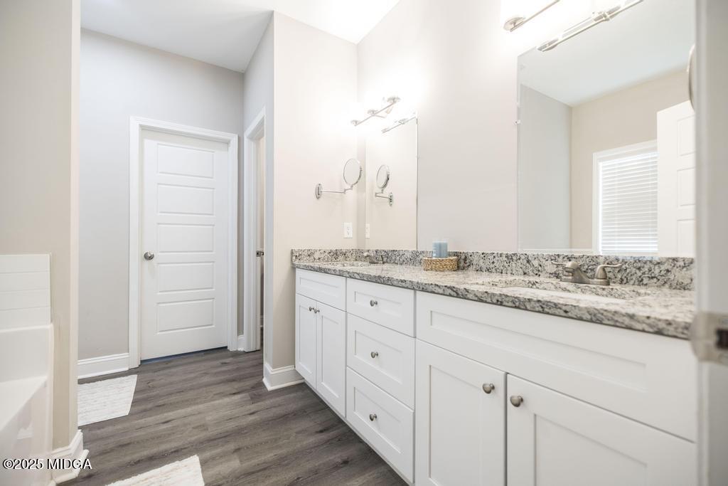 219 Diamond Place Gray, GA 31032 - Photo 28 of 42 a bathroom with a granite countertop sink and a mirror