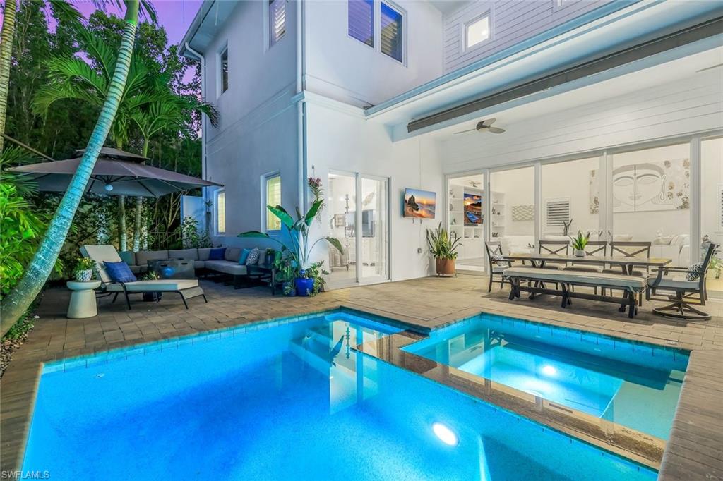 9161 Mercato Way Naples, FL 34108 - Photo 1 of 50 a living room with furniture and a floor to ceiling window