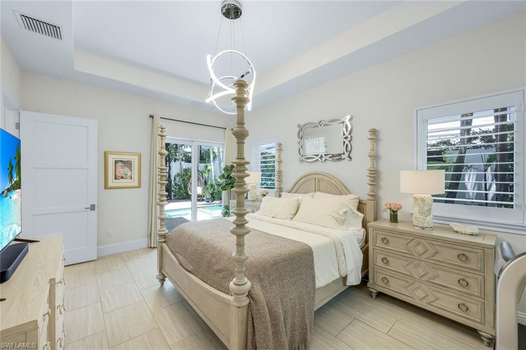9161 Mercato Way Naples, FL 34108 - Photo 15 of 50 a bedroom with a bed and window