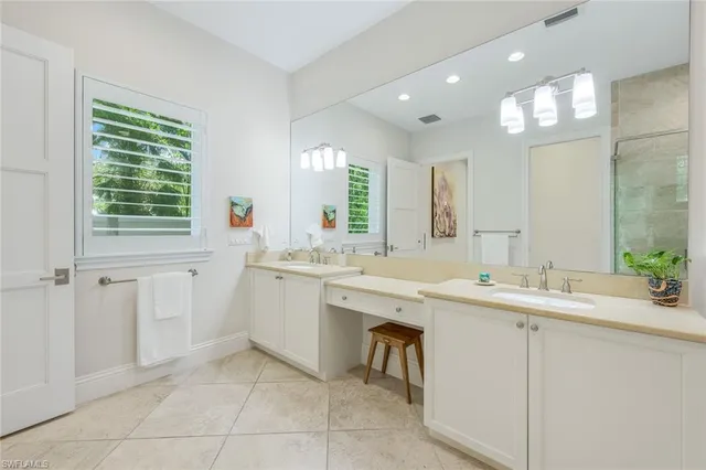 a large white bathroom with a sink a mirror and a bathtub