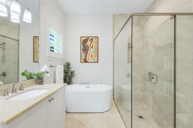 a bathroom with a tub sink and mirror