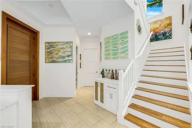 a view of entryway with furniture and stairs