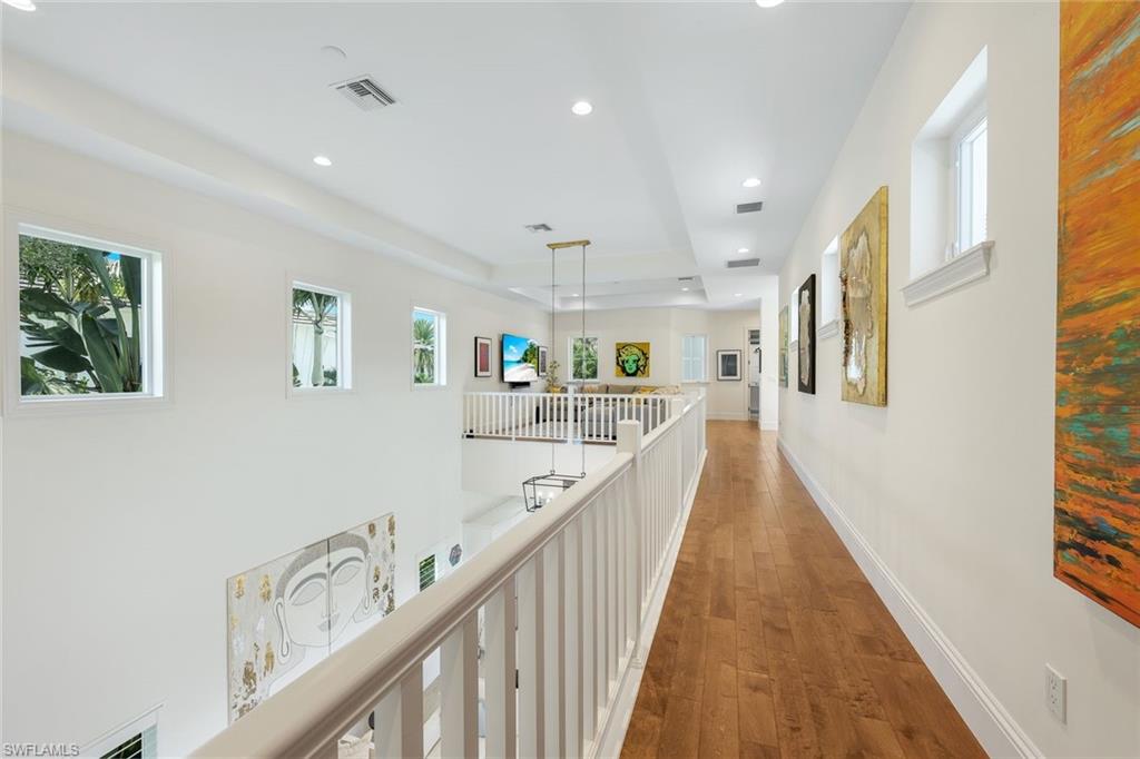 9161 Mercato Way Naples, FL 34108 - Photo 22 of 50 a view of a hallway with wooden floor and staircase