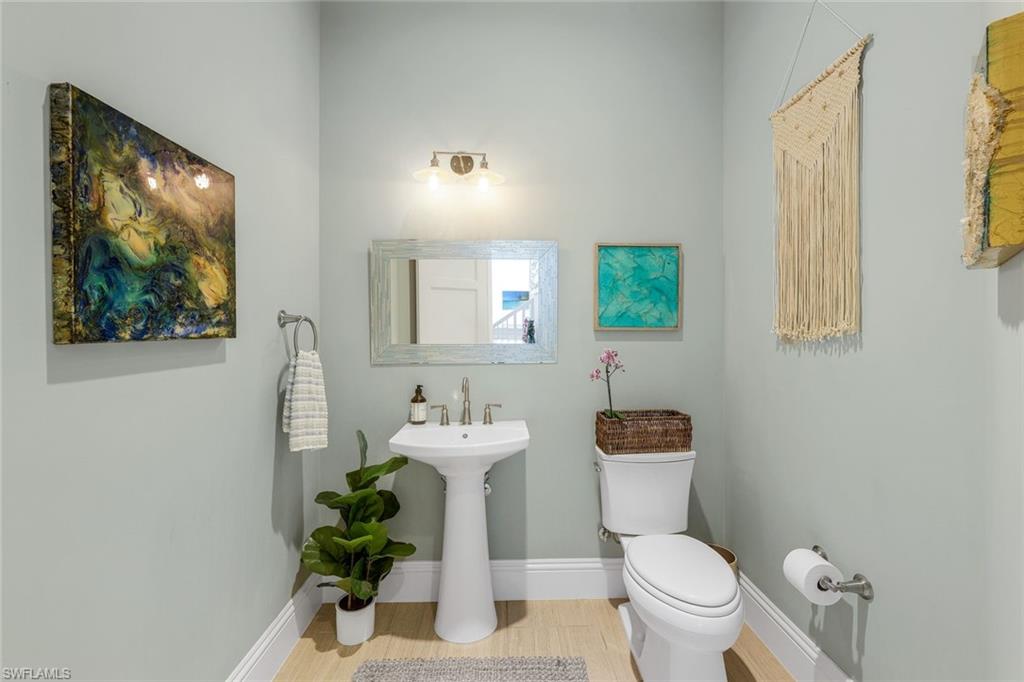 9161 Mercato Way Naples, FL 34108 - Photo 29 of 50 a bathroom with a toilet sink and mirror