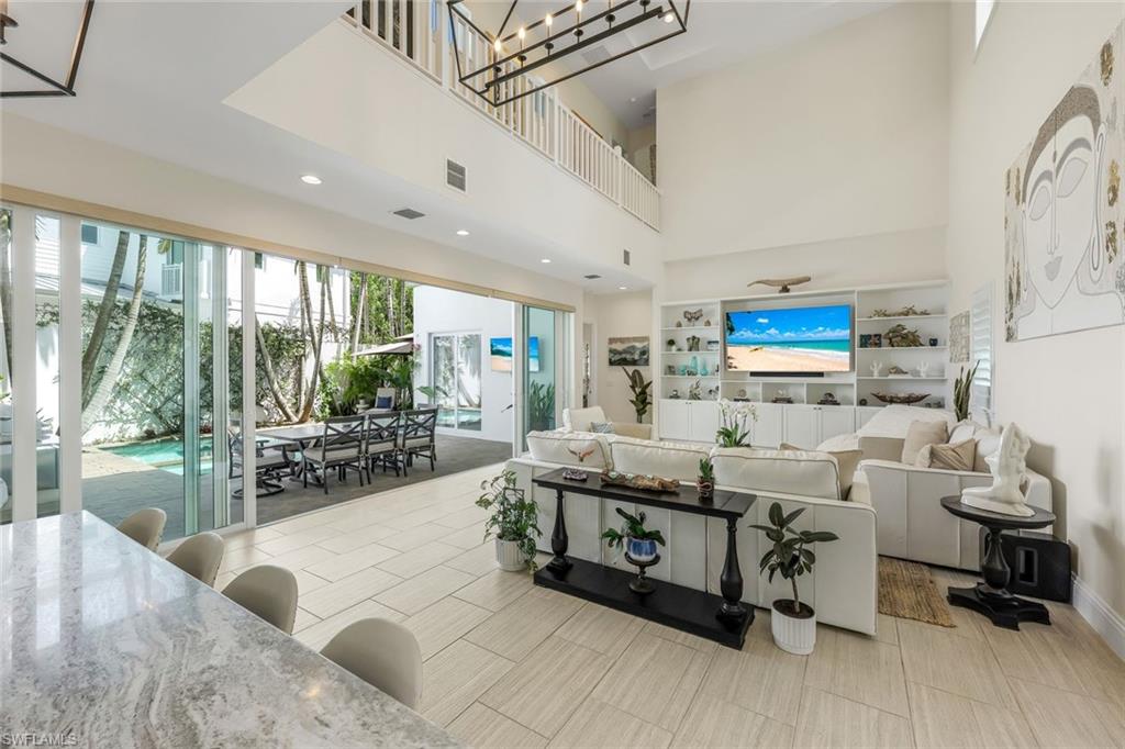 9161 Mercato Way Naples, FL 34108 - Photo 3 of 50 a living room with furniture and a flat screen tv