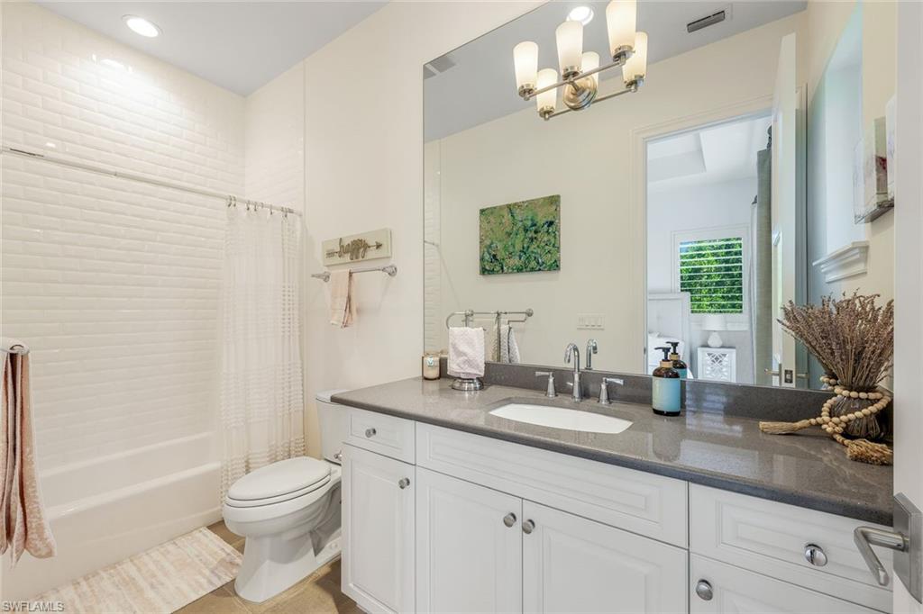 9161 Mercato Way Naples, FL 34108 - Photo 32 of 50 a bathroom with a double vanity sink toilet and shower