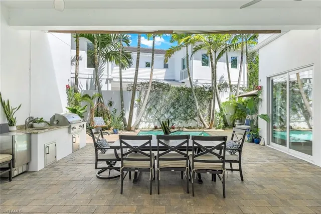 a view of a dining room with furniture large windows and wooden floor
