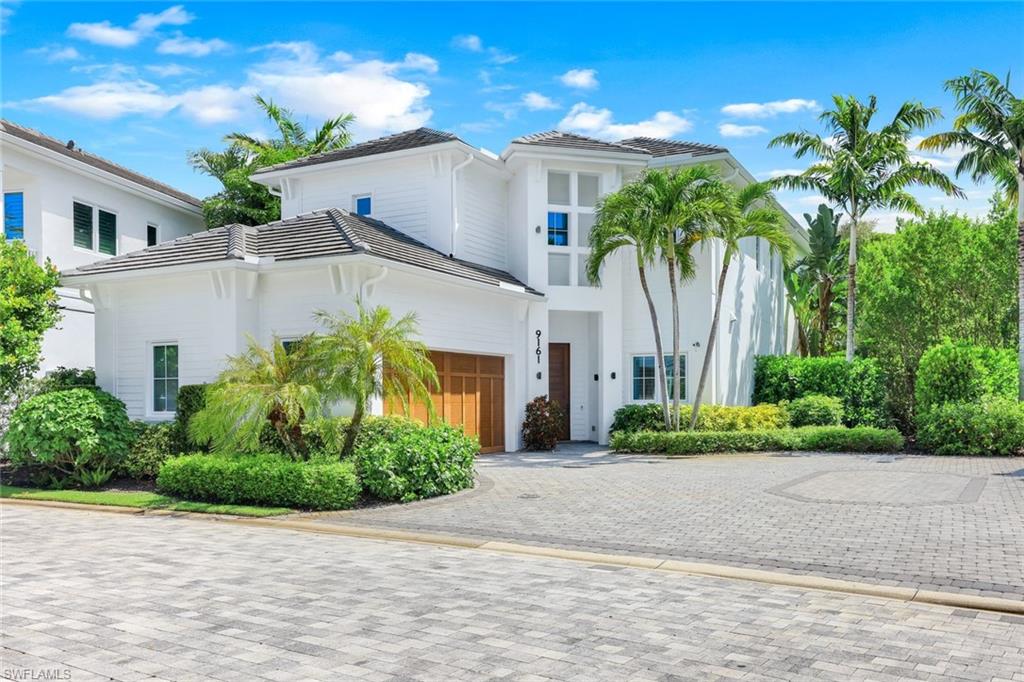 9161 Mercato Way Naples, FL 34108 - Photo 35 of 50 a front view of a house with a yard and a garage