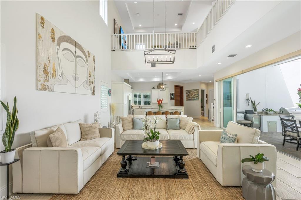 9161 Mercato Way Naples, FL 34108 - Photo 4 of 50 a living room with furniture and a chandelier