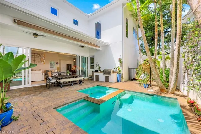 a living room with patio furniture and a potted plant