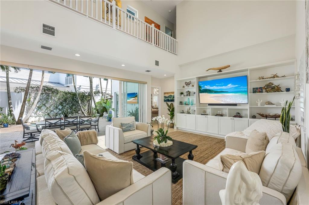 9161 Mercato Way Naples, FL 34108 - Photo 6 of 50 a living room with furniture and a flat screen tv