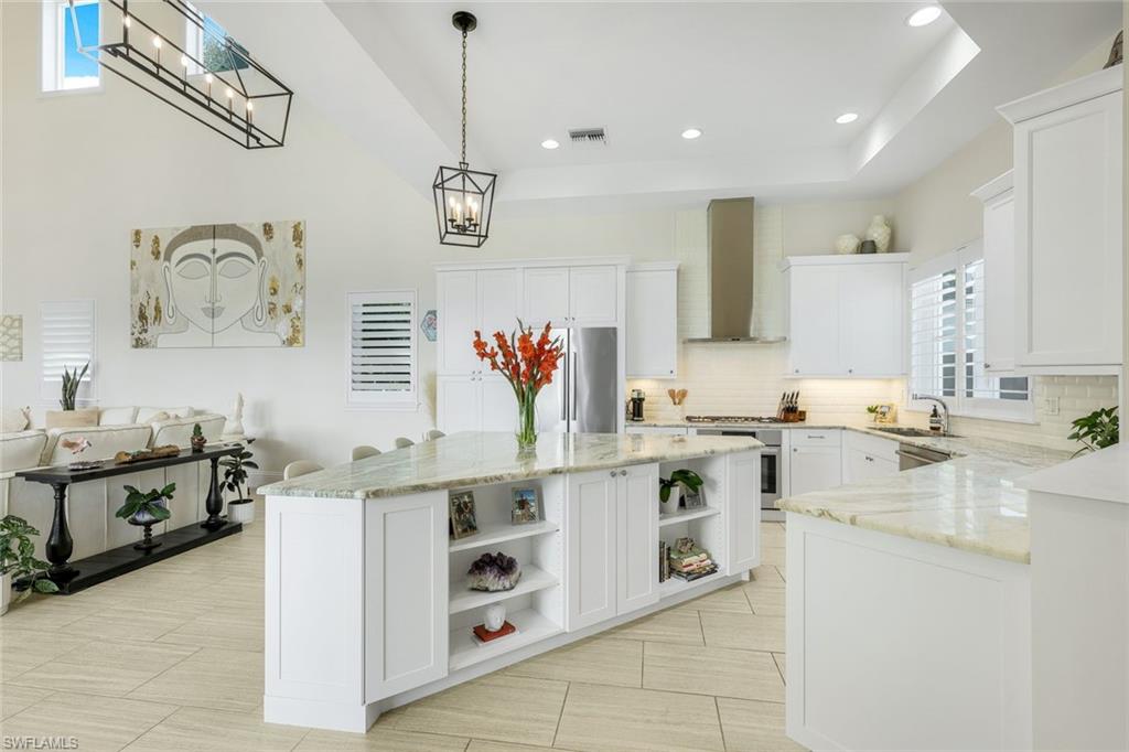 9161 Mercato Way Naples, FL 34108 - Photo 9 of 50 a kitchen with a sink stove and cabinets