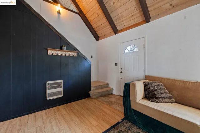 a bed sitting in a bedroom next to a window