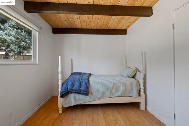 a bedroom with bed and window