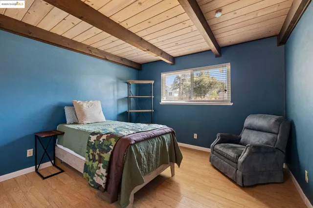 a bedroom with a large bed and a window