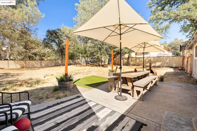 a view of a patio with a table and chairs and potted plants