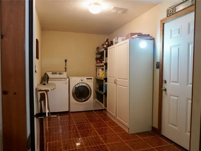 a bedroom with a bed a flat screen tv and windows