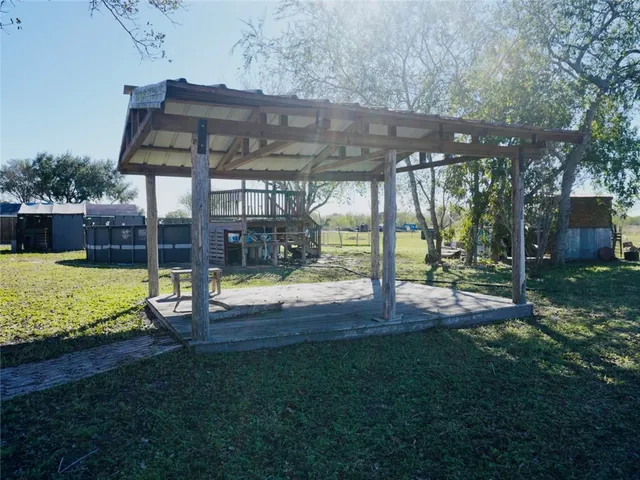 a big yard with lots of green space and trees in the background