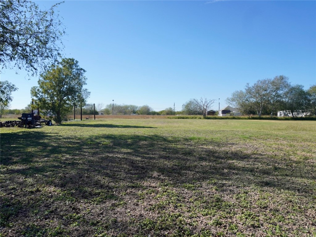 7643 County Road 2415 Sinton, TX 78387 - Photo 24 of 25 a big yard with lots of green space and trees in the background