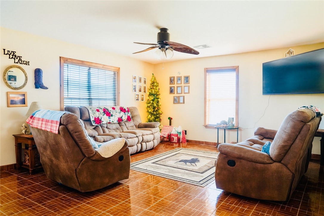 7643 County Road 2415 Sinton, TX 78387 - Photo 7 of 25 a living room with furniture a flat screen tv and a window